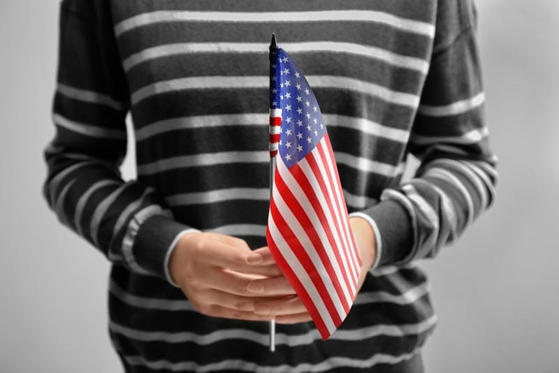 naturalization lawyer boston ma woman holding American flag